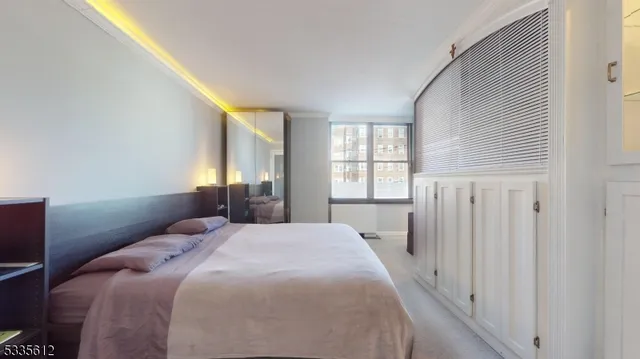 a bedroom with a bed and a window