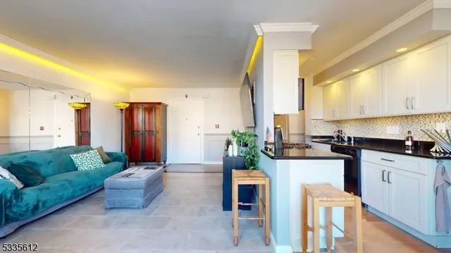 a kitchen with stainless steel appliances granite countertop a sink a stove and a refrigerator