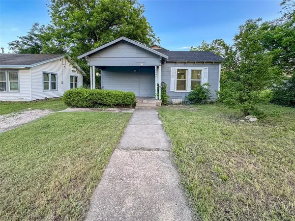 a front view of a house with yard and green space