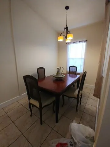 a dining room with furniture and window