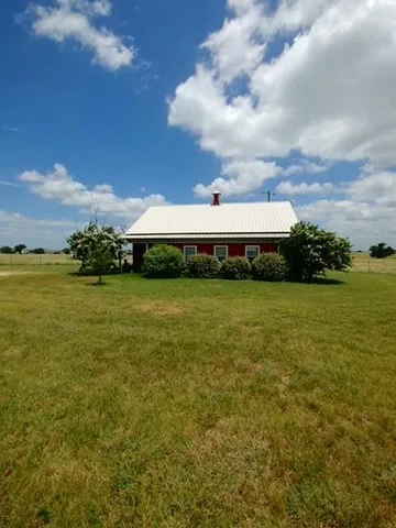 a view of a big yard with table and chairs