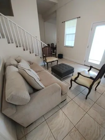 a living room with furniture and a window