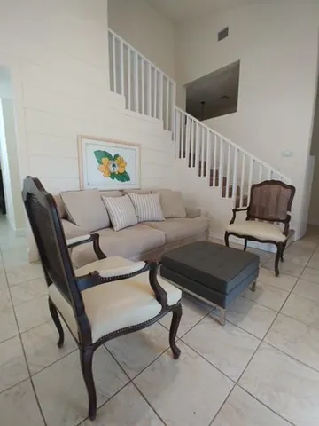 a living room with furniture and a rug