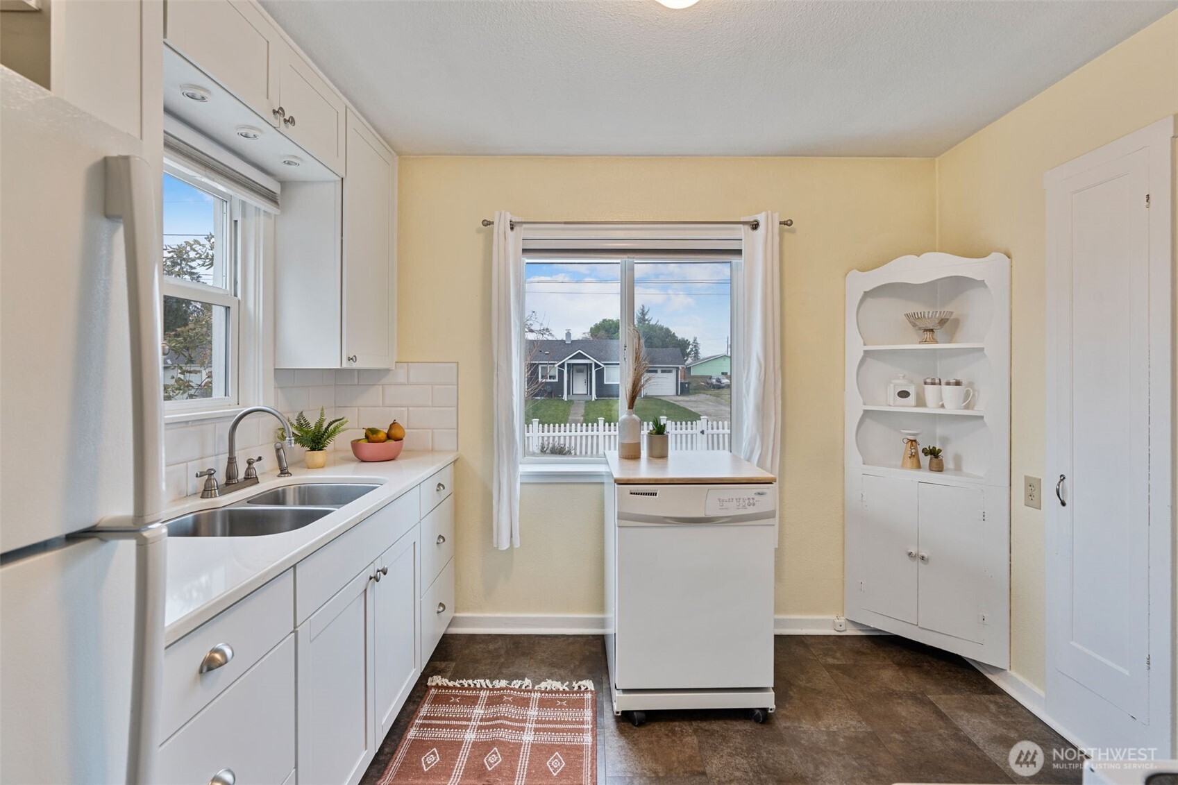 1027 South Rochester Street Tacoma, WA 98465 - Photo 12 of 29 a kitchen with sink cabinets and window