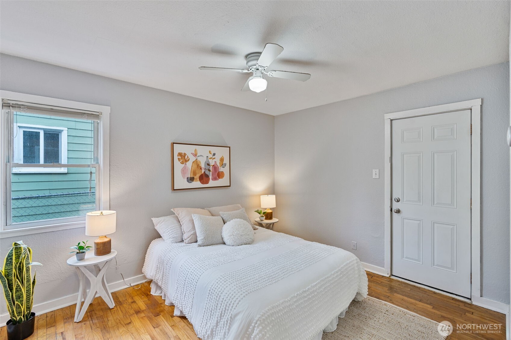 1027 South Rochester Street Tacoma, WA 98465 - Photo 14 of 29 a bedroom with a bed and a chandelier