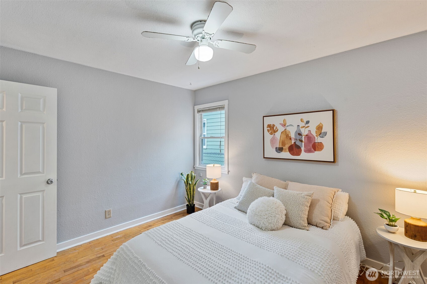 1027 South Rochester Street Tacoma, WA 98465 - Photo 15 of 29 a bedroom with a bed and a chandelier