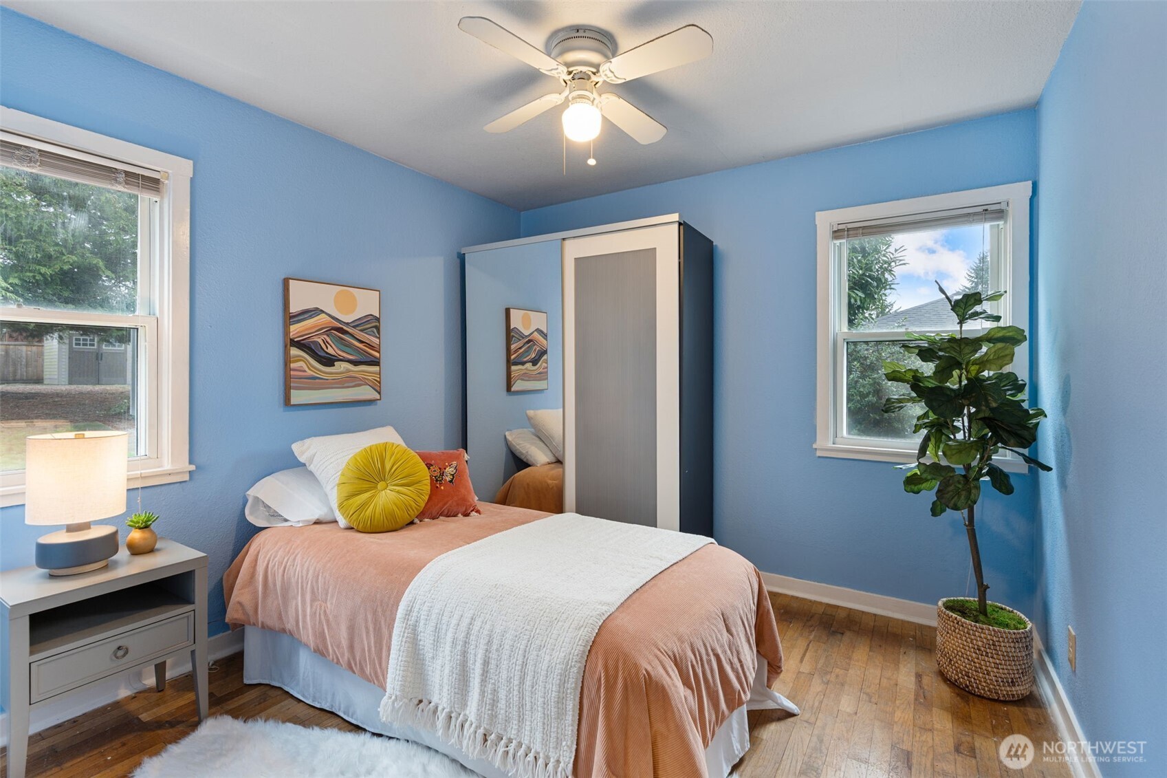 1027 South Rochester Street Tacoma, WA 98465 - Photo 16 of 29 a bedroom with a bed and a chandelier