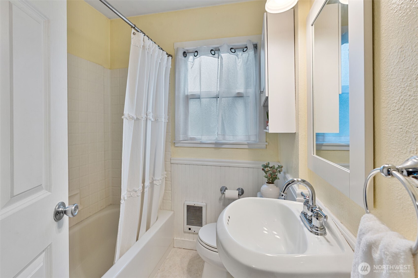 1027 South Rochester Street Tacoma, WA 98465 - Photo 18 of 29 a bathroom with a sink a toilet and shower