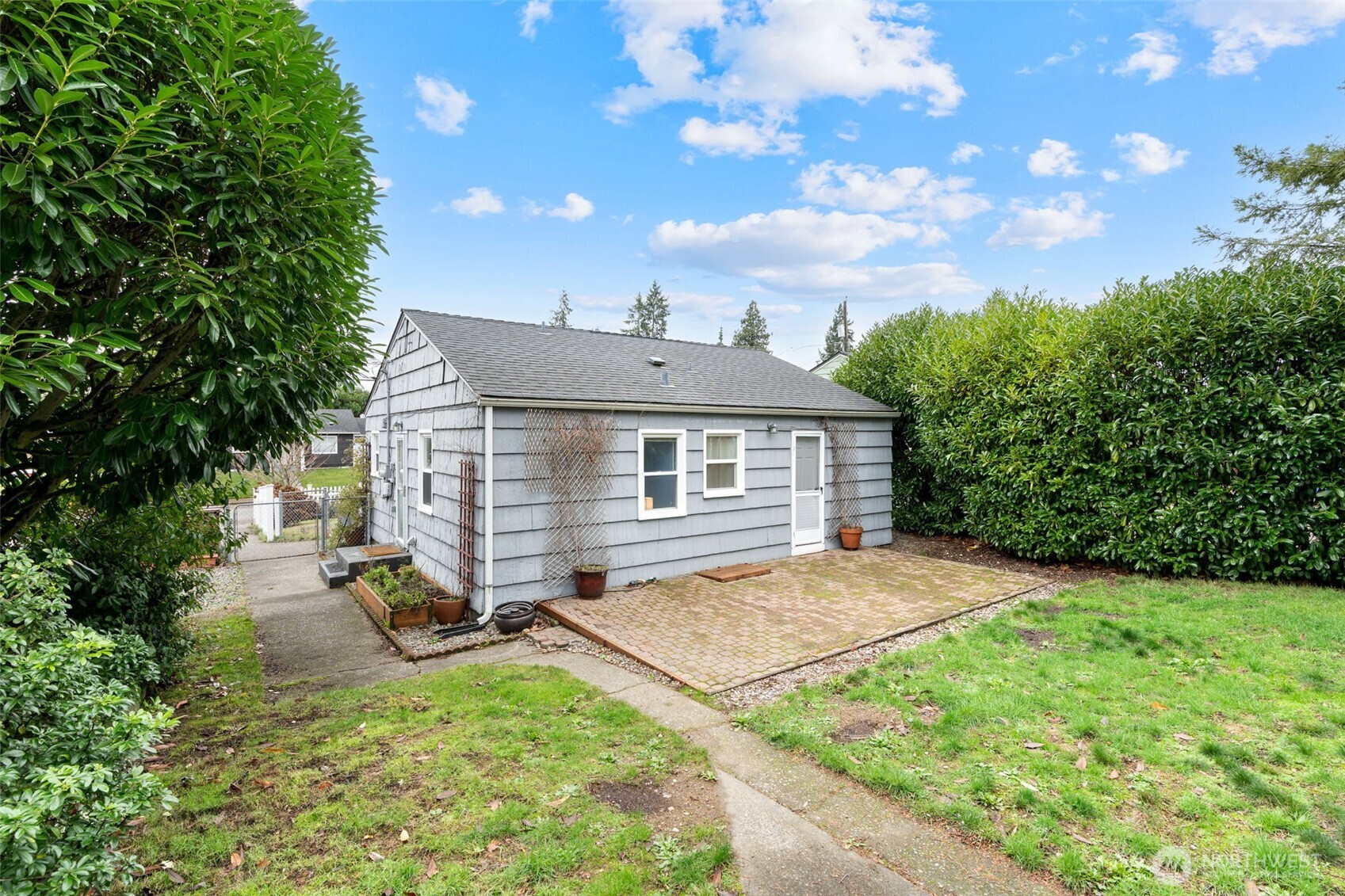 1027 South Rochester Street Tacoma, WA 98465 - Photo 20 of 29 a view of backyard of house with wooden fence