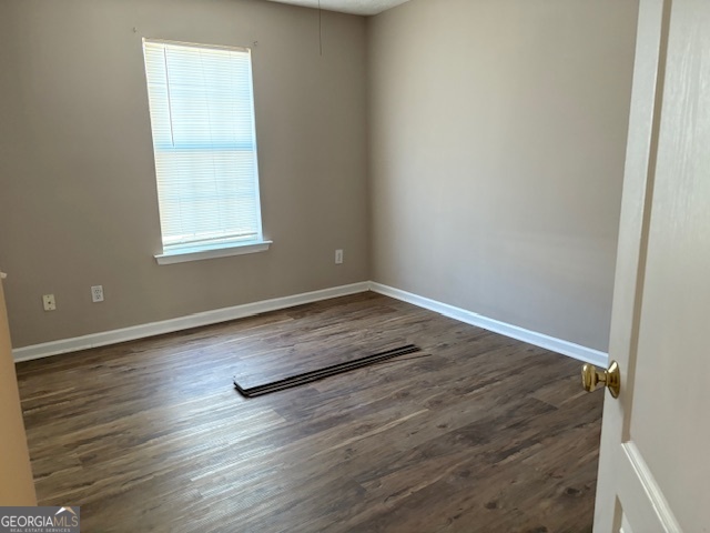 10725 Barberry Drive Hampton, GA 30228 - Photo 14 of 18 an empty room with wooden floor and windows