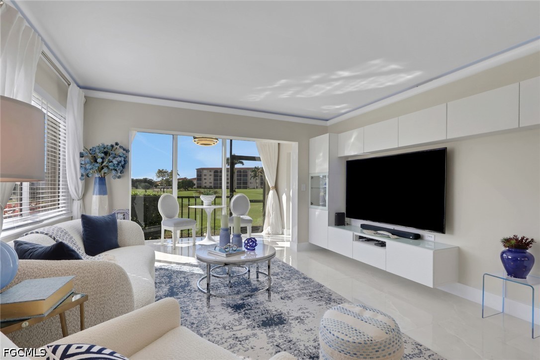 9 High Point Circle North, Unit 101 Naples, FL 34103 - Photo 2 of 49 a living room with furniture a flat screen tv and floor to ceiling window