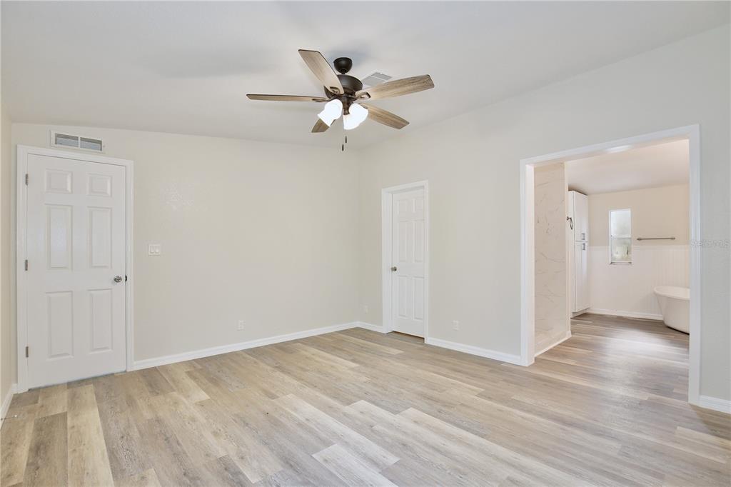 15330 Apache Pass Eustis, FL 32726 - Photo 12 of 44 a view of an empty room with wooden floor