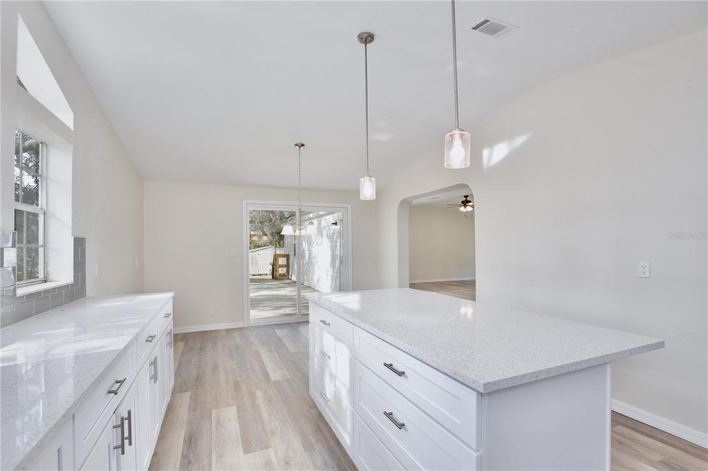 15330 Apache Pass Eustis, FL 32726 - Photo 15 of 44 a spacious bathroom with a sink a vanity a mirror and shower