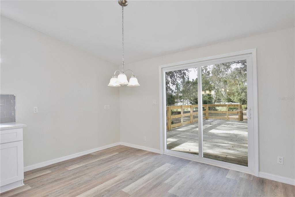 15330 Apache Pass Eustis, FL 32726 - Photo 16 of 44 a view of empty room with wooden floor and fan