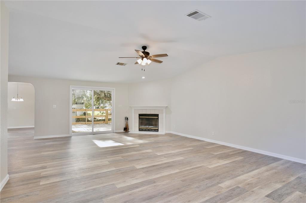 15330 Apache Pass Eustis, FL 32726 - Photo 18 of 44 a view of an empty room with a window and fireplace