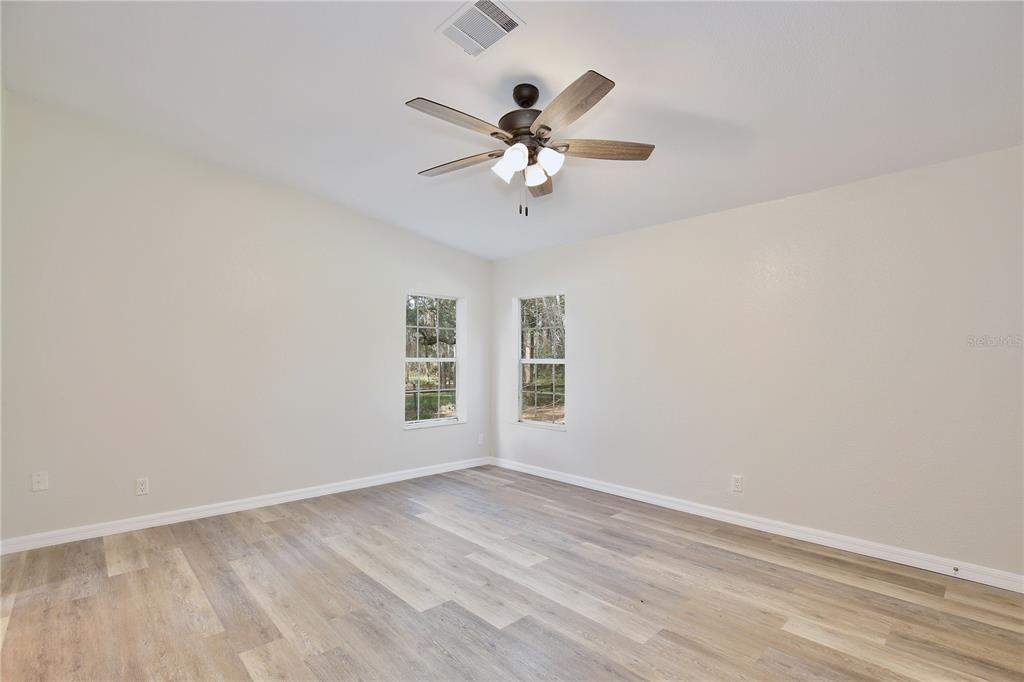 15330 Apache Pass Eustis, FL 32726 - Photo 20 of 44 wooden floor in an empty room with a window