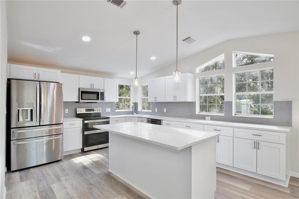 15330 Apache Pass Eustis, FL 32726 - Photo 2 of 44 a kitchen with a sink stainless steel appliances and window