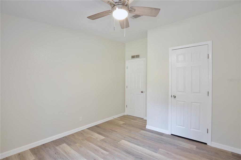 15330 Apache Pass Eustis, FL 32726 - Photo 25 of 44 a view of an empty room with wooden floor