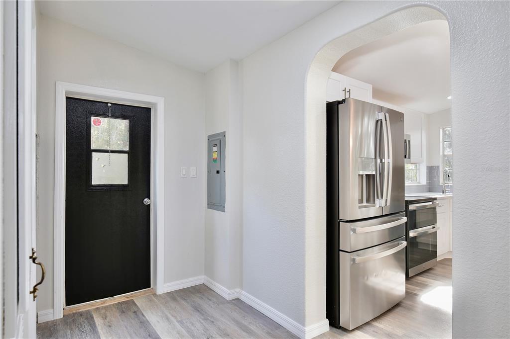 15330 Apache Pass Eustis, FL 32726 - Photo 30 of 44 a view of kitchen with stainless steel appliances wooden floor and chair