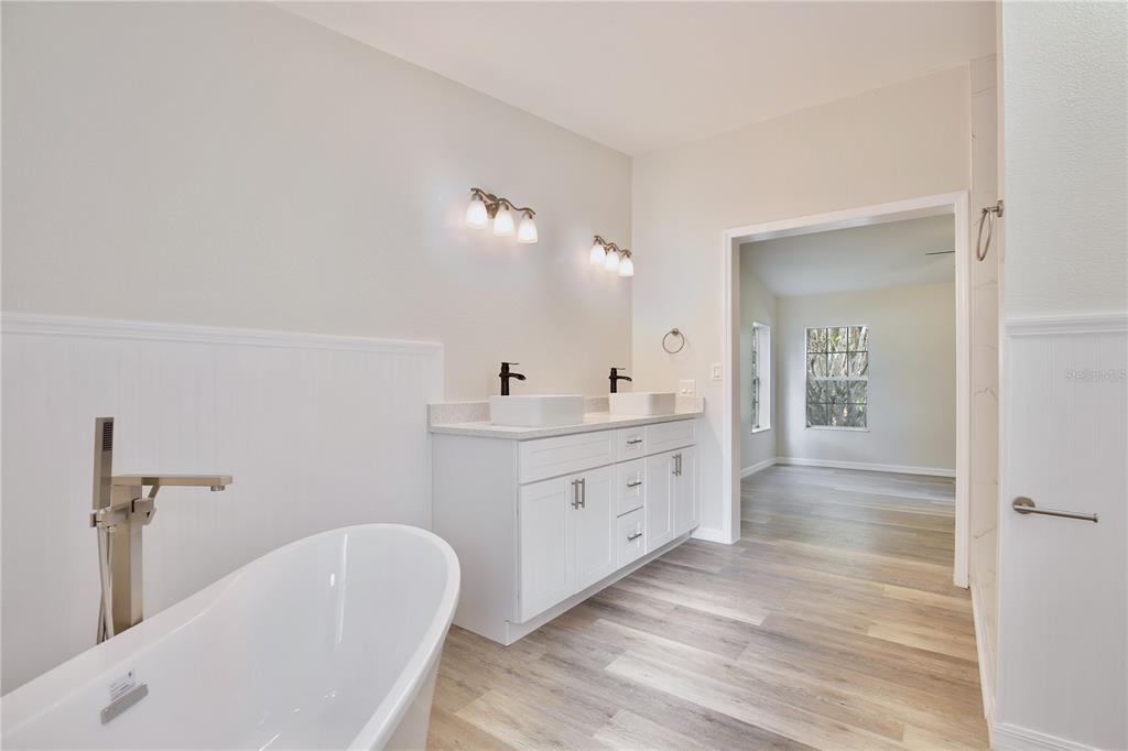 15330 Apache Pass Eustis, FL 32726 - Photo 6 of 44 a bathroom with a granite countertop sink mirror and bathtub