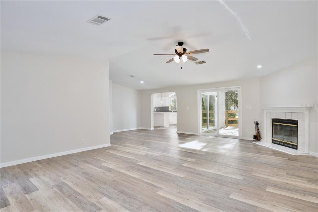 15330 Apache Pass Eustis, FL 32726 - Photo 7 of 44 a view of an empty room with a fireplace and a window