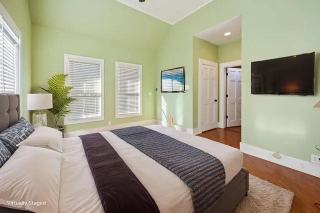 a bedroom with a bed and a flat screen tv