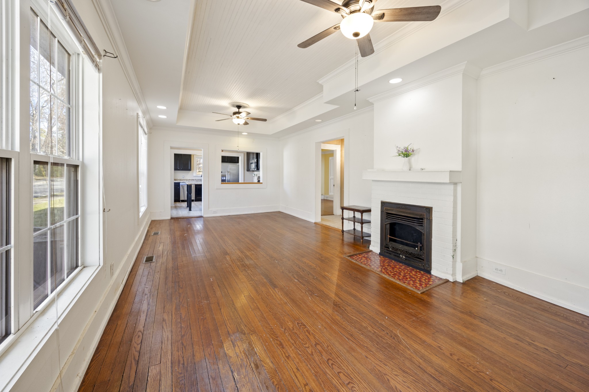 801 South High Street Winchester, TN 37398 - Photo 2 of 49 a view of a livingroom with a fireplace a ceiling fan and wooden floor
