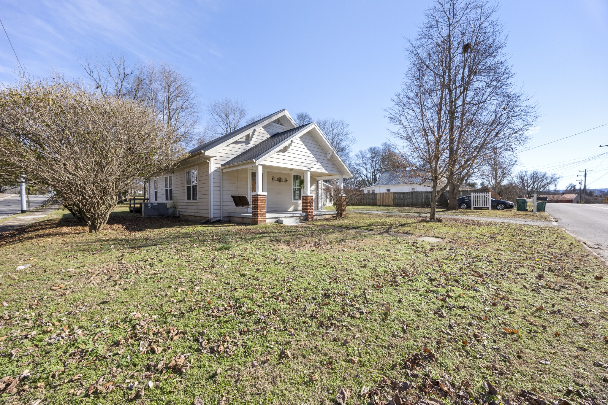 801 South High Street Winchester, TN 37398 - Photo 38 of 49 a front view of a house with a yard covered with snow and trees