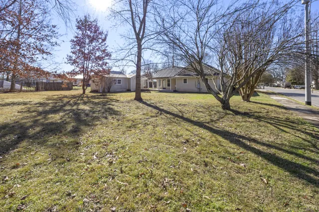 a view of yard covered with snow in front of house
