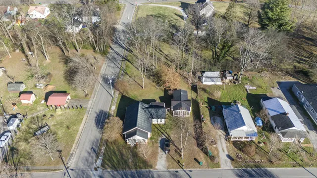 an aerial view of a house with a yard