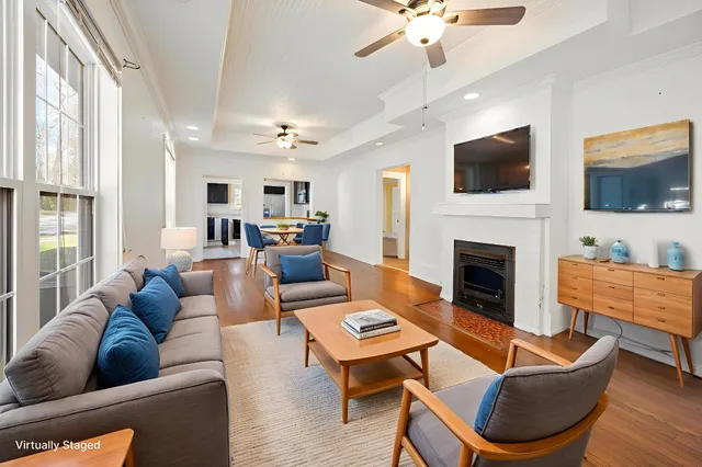 a living room with furniture a flat screen tv and a fireplace
