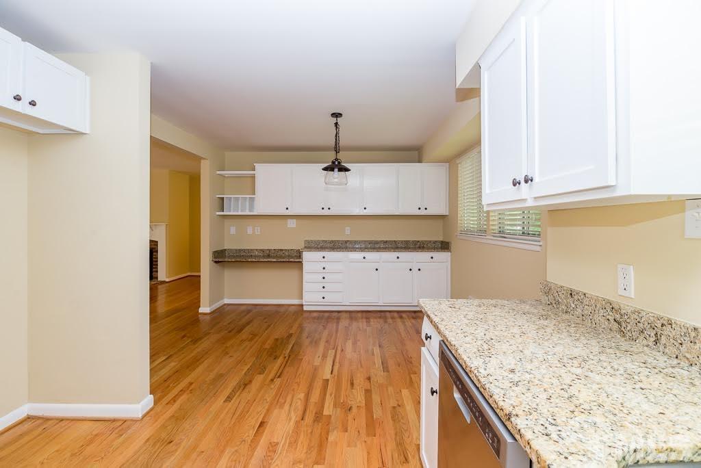 4220 Rowan Street Raleigh, NC 27609 - Photo 7 of 24 a kitchen with granite countertop a sink and a stove top oven