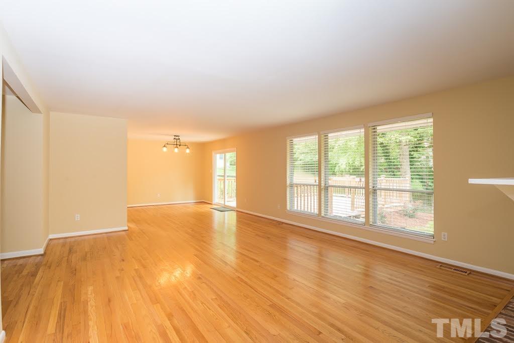 4220 Rowan Street Raleigh, NC 27609 - Photo 24 of 24 a view of an empty room with wooden floor and a window