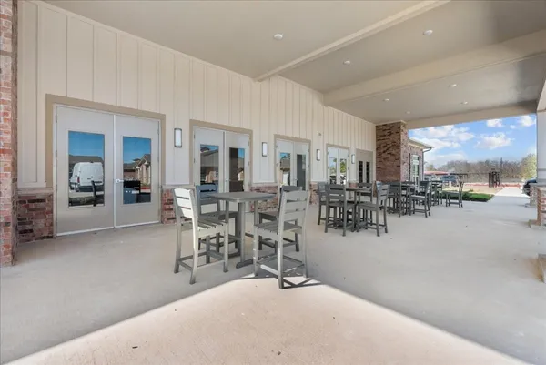 a room with lots of table chair and view of living room