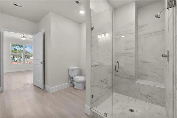 a bathroom with a shower and a toilet