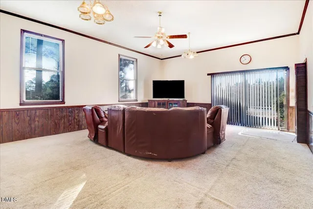 a spacious bedroom with a bed and a flat screen tv