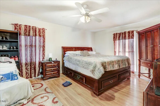 a bedroom with a bed and a book shelf