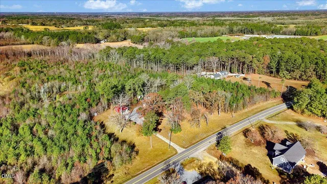 a view of a yard with wooden fence