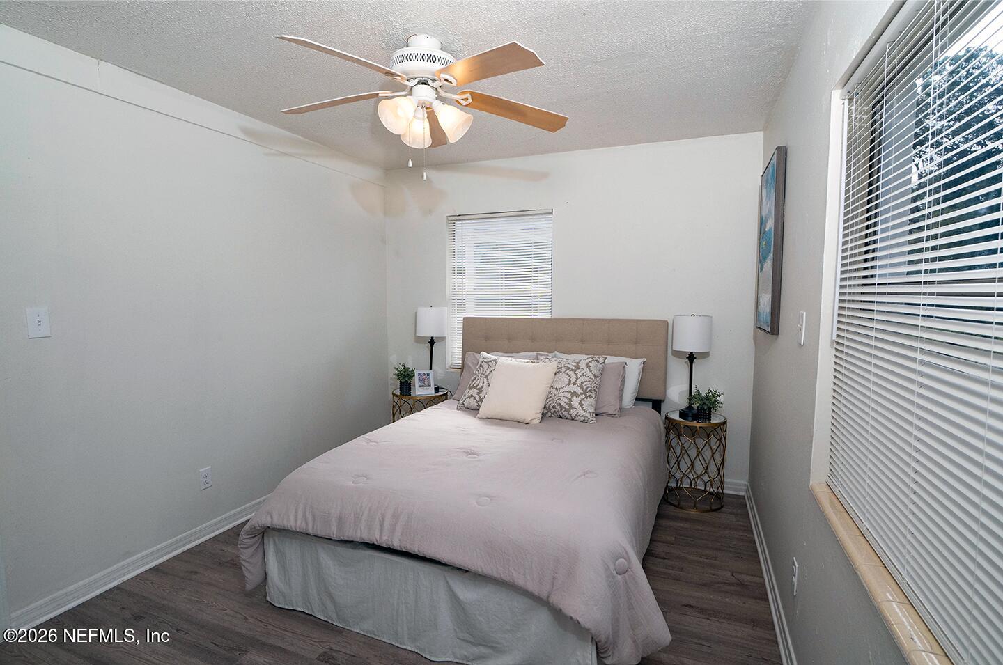 10250 Briarcliff Road East Jacksonville, FL 32218 - Photo 20 of 24 a bedroom with a bed and a chandelier