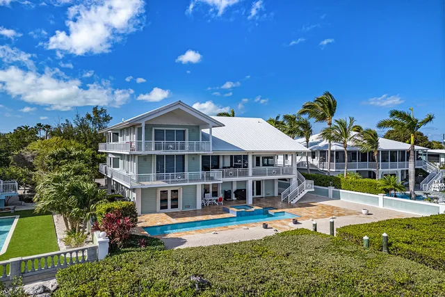 an aerial view of a house with a yard and a fountain