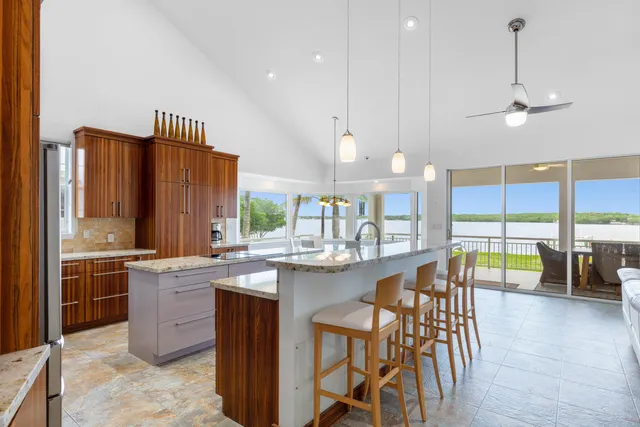 a kitchen with stainless steel appliances kitchen island granite countertop a sink and counter space