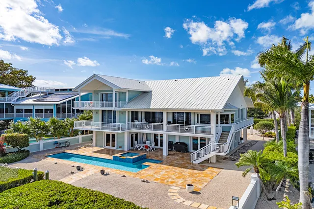 a view of a house with backyard porch and sitting area