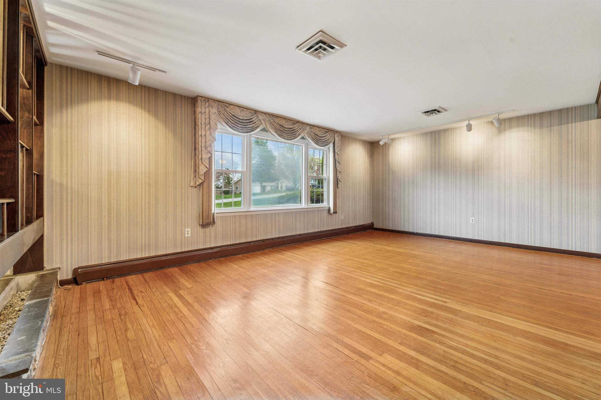 1220 Sylvan Road West Chester, PA 19382 - Photo 17 of 33 a view of an empty room with wooden floor and a window