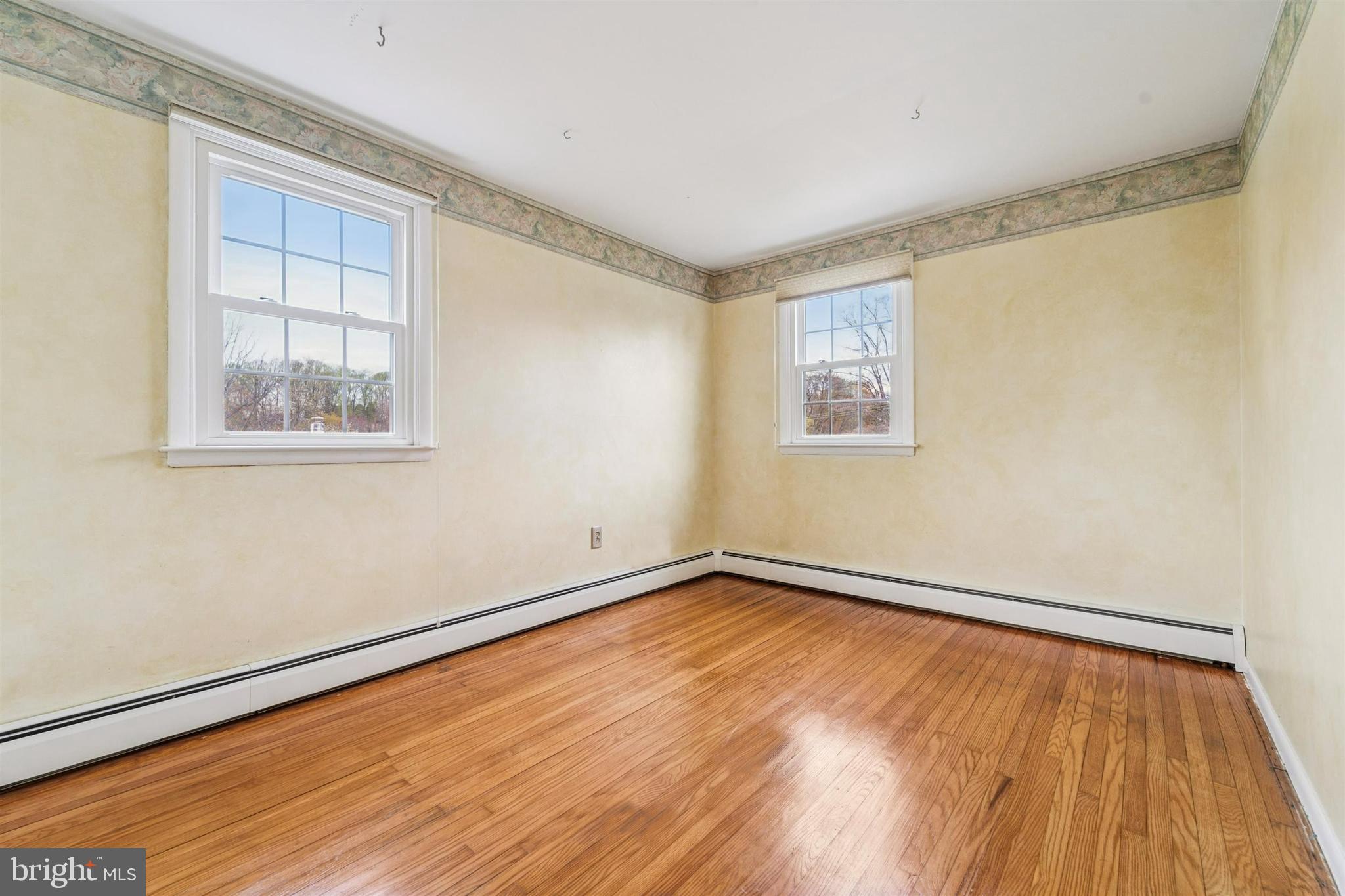 1220 Sylvan Road West Chester, PA 19382 - Photo 22 of 33 an empty room with wooden floor and windows