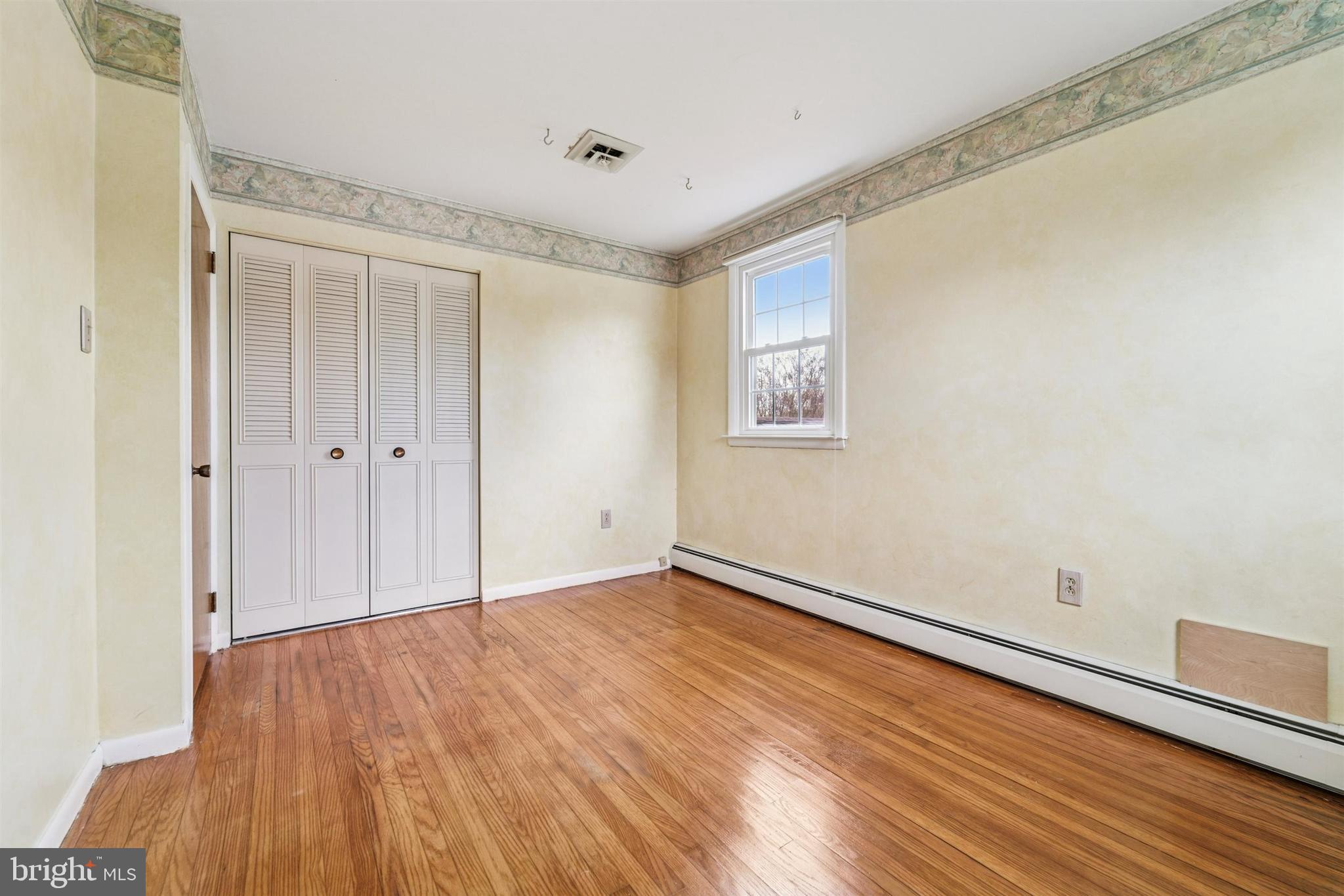 1220 Sylvan Road West Chester, PA 19382 - Photo 25 of 33 a view of an empty room with wooden floor and a window