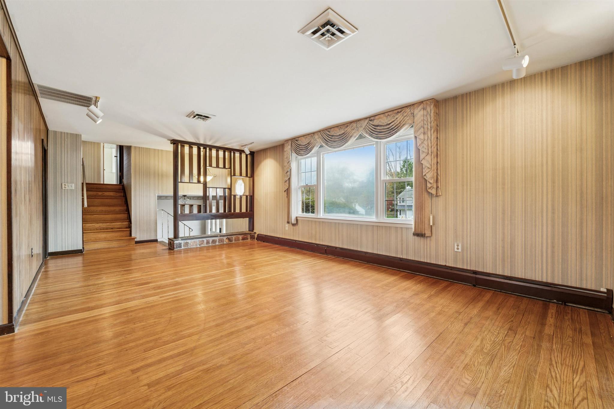 1220 Sylvan Road West Chester, PA 19382 - Photo 6 of 33 a view of an empty room with a window and wooden floor
