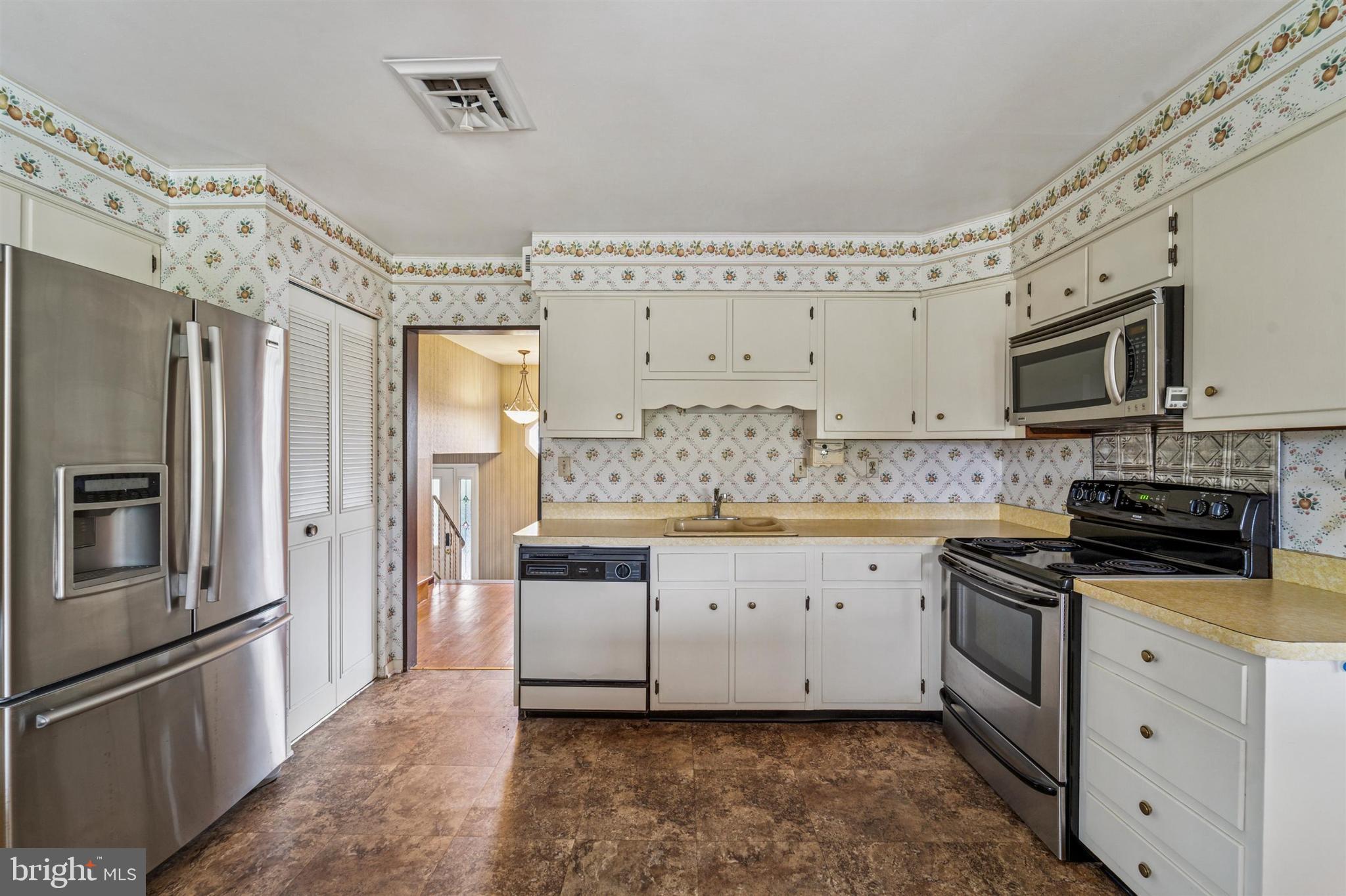 1220 Sylvan Road West Chester, PA 19382 - Photo 7 of 33 a kitchen with granite countertop a refrigerator stove and sink
