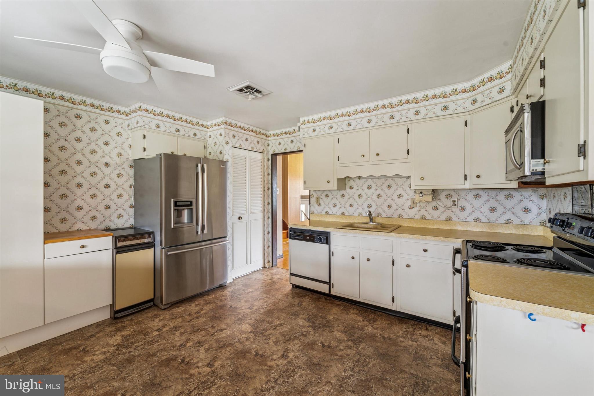 1220 Sylvan Road West Chester, PA 19382 - Photo 9 of 33 a kitchen with granite countertop a refrigerator stove and white cabinets