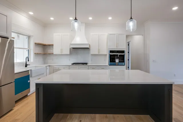 a kitchen with stainless steel appliances granite countertop a sink stove and cabinets