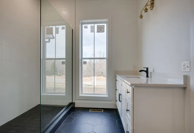 a bathroom with a double vanity sink and a bathtub
